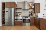 Kitchen with 5 burner gas stove, dishwasher, microwave, Keurig Duo and refrigerator